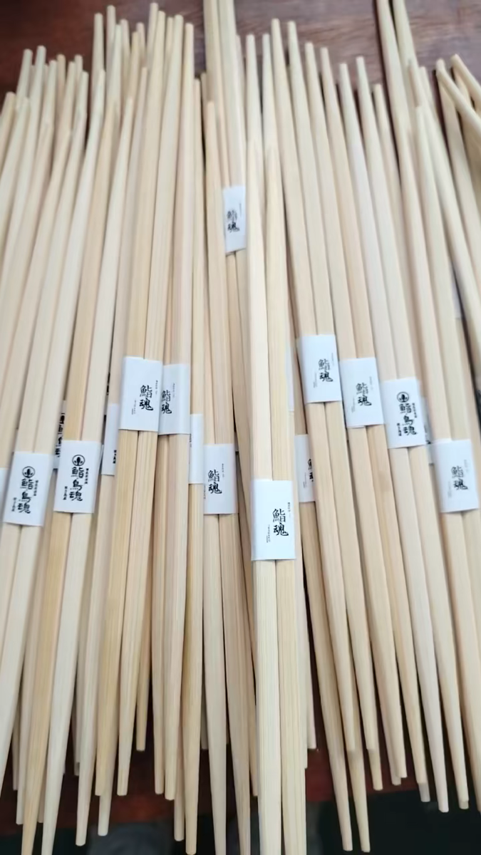 Natural bamboo chopsticks prepared for custom paper branding